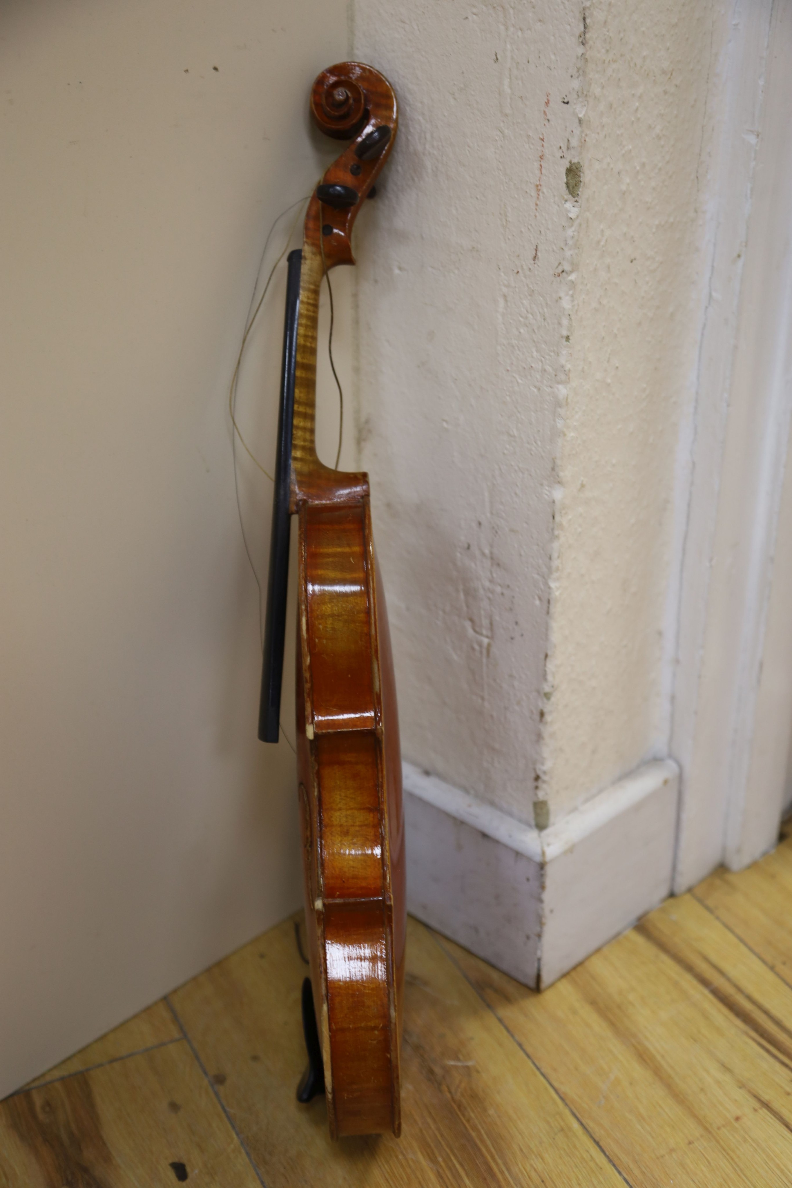 A Stradivarius copy violin and two bows and another bow, both cased, backs 33cm and 30cm